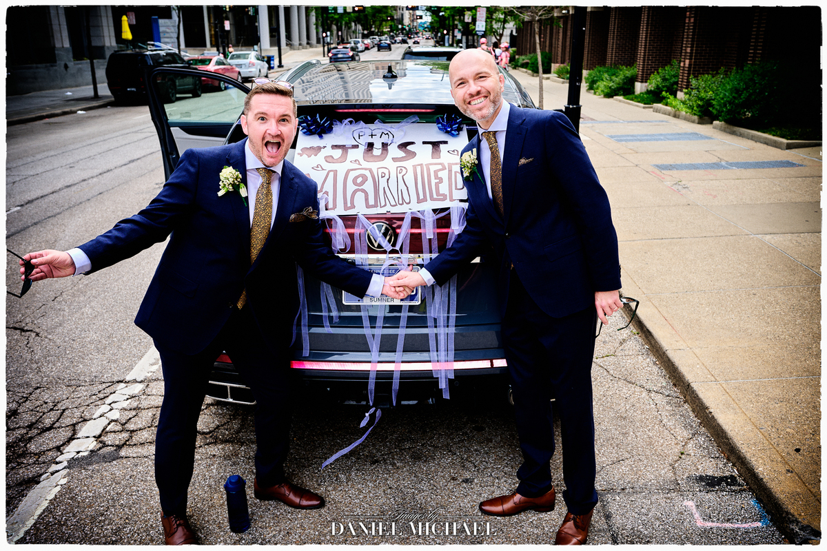 LGBTQ+ Wedding Photo with their Decorated Just Married Car